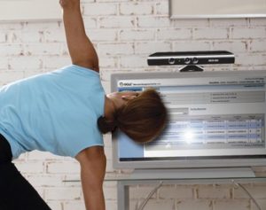 Woman doing yoga while watching exercise video